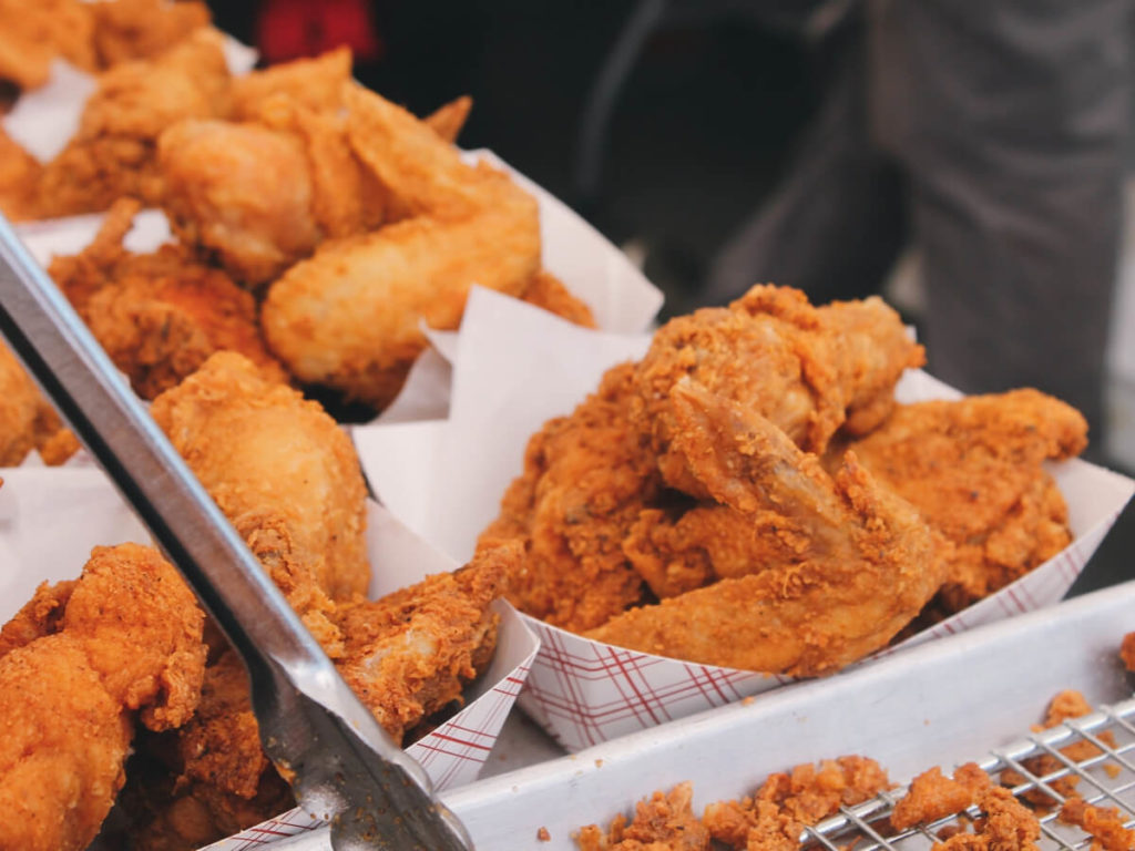 Chicken with Henny Penny breading and seasoning on it