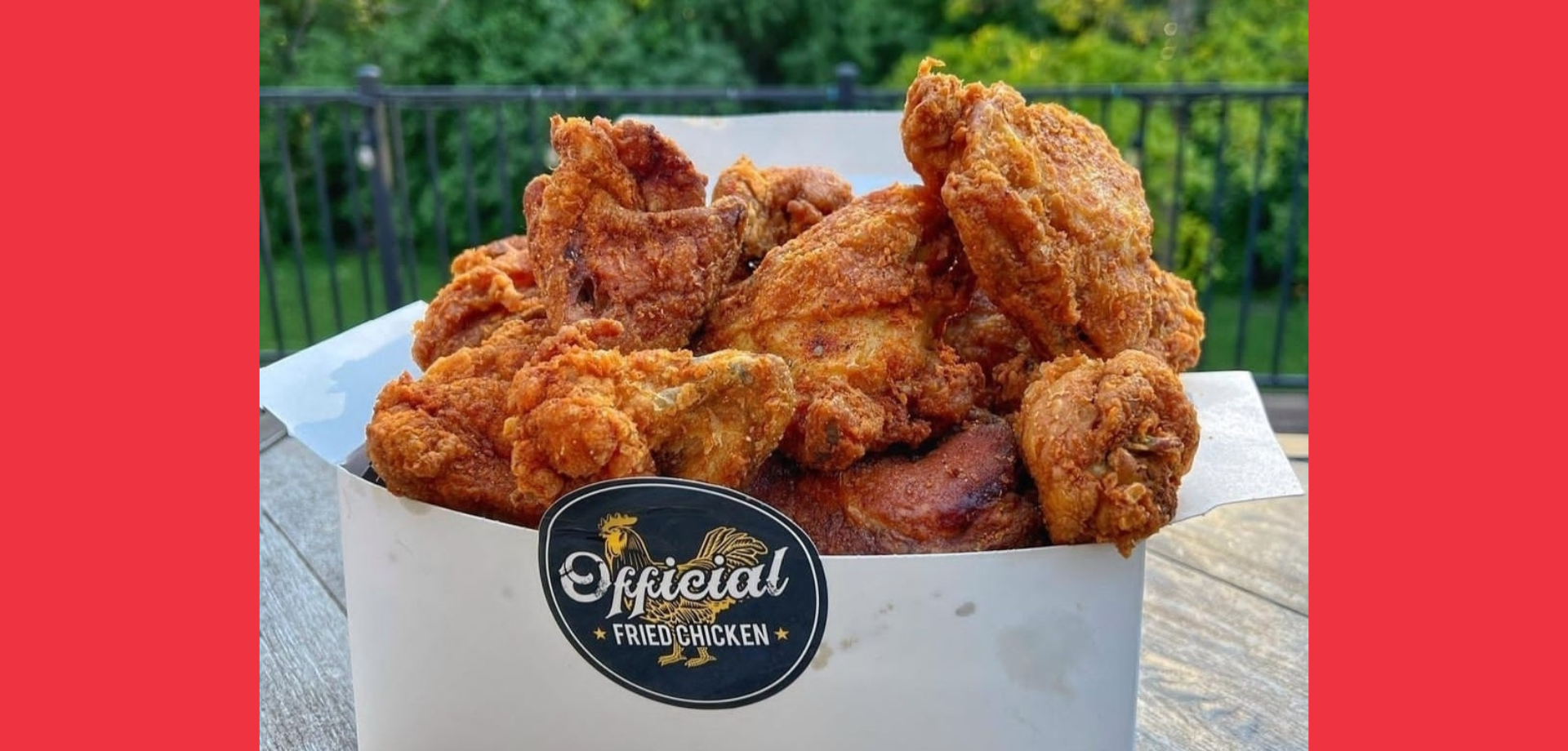 White takeout box filled with golden-brown fried chicken pieces and a label reading Official Fried Chicken.